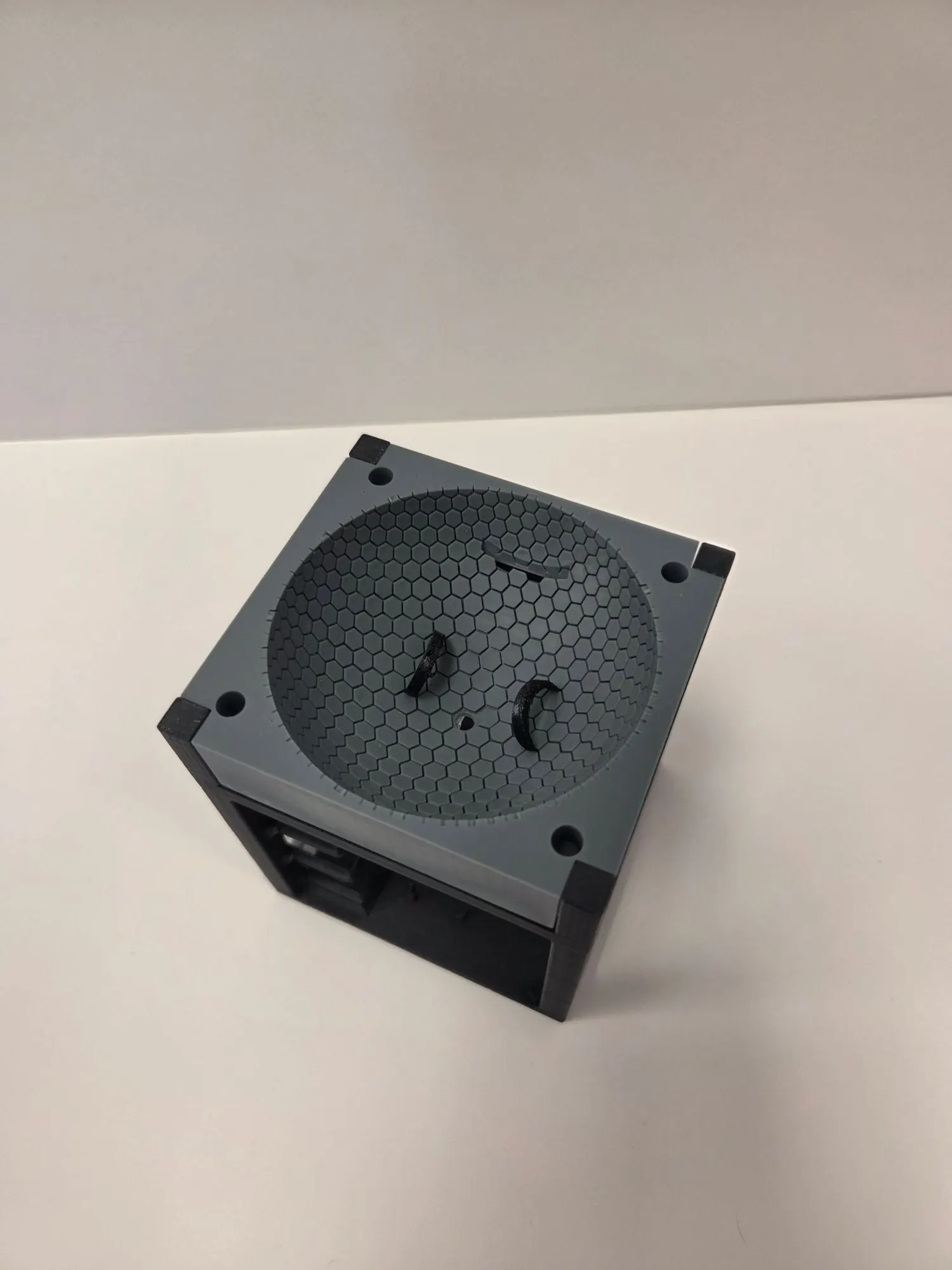 The printed grey hex dome sitting on top of the dark grey nanolab frame, with two slots cut into the dome for plant clips